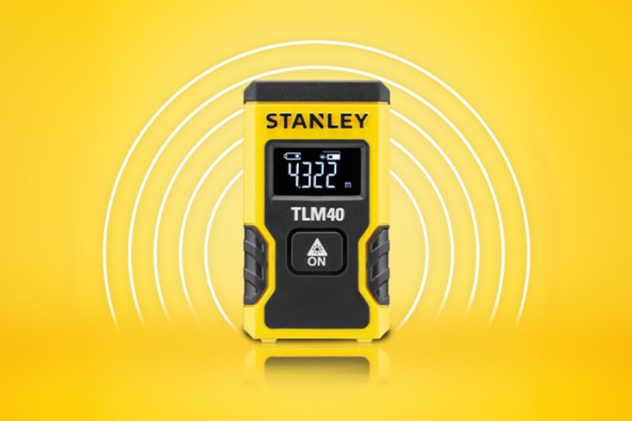 A Stanley branded laser distance measurer on a yellow background.