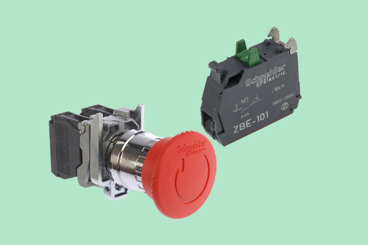 A Schneider emergency stop push button next to a push button contact block on a pale green background