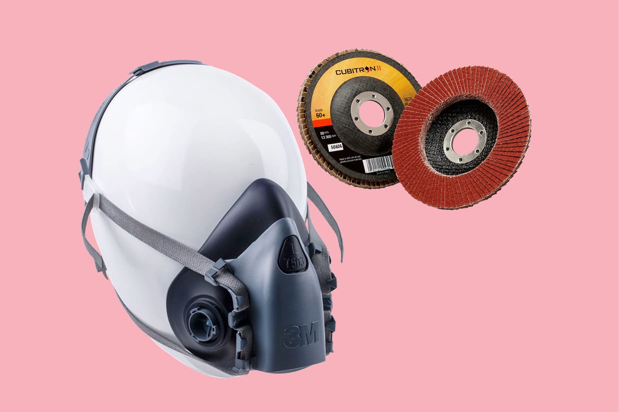 A 3M respirator mask and cubitron abrasive next to each other on a pale red background